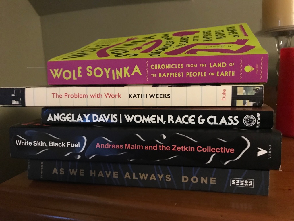 Stack of five books: As We Have Always Done; White Skin, Black Fuel; Women, Race & Class; The Problem with Work; and Chronicles from the Land of the Happiest People on Earth. 